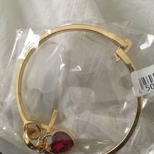 Gold bracelet with a ruby heart and gold cross